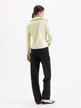 Pantalón de corte recto confeccionado en tela sastrera, con cintura de cuero vacuno, raya marcada en el centro de las piernas y bolsillos laterales.