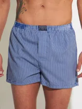 Bóxer de algodón blanco con estampado de flores pequeñas color celeste, con cintura elástica y logo de la marca en el centro.