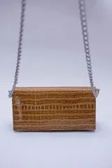 Cartera negra con textura símil cocodrilo y cadena metálica plateada.