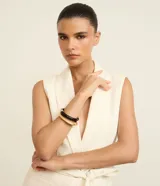 Kit de dos braceletes rígidos, uno de color negro y otro dorado, de diseño minimalista y elegante.