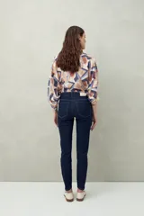 Pantalón chupín negro de tiro alto, confeccionado en denim suave y levemente elástico, con bolsillos delanteros y traseros.