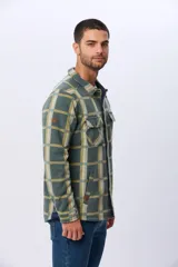 Sobrecamisa leñadora de polar a cuadros en tonos verde militar, beige y azul claro. Cuenta con dos bolsillos frontales con solapa, dos bolsillos laterales y cierre con botones a presión. Interior de micropolar.