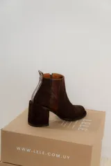 Botinetas de cuero color marrón, con diseño de caña baja, taco cuadrado y cierre lateral.