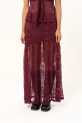 Pollera larga de encaje color bordó, con diseño transparente y volado en el ruedo.