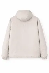 Campera con capucha, color beige, con cierre frontal oculto, dos bolsillos verticales con cierre en el pecho y dos bolsillos laterales. Cuenta con puños elásticos.