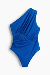 Body colaless azul de un hombro en punto suave, con costuras fruncidas adelante y en el lateral que crean un efecto drapeado, y cierre de botones a presión en la parte inferior.