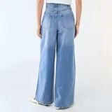 Jean de corte wide leg y tiro alto, confeccionado en denim azul. Presenta pinzas en la cintura, cierre frontal con botón y bolsillos laterales.