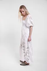 Vestido largo de encaje blanco con cuerpo fruncido elastizado, mangas cortas abullonadas y falda con vuelo.