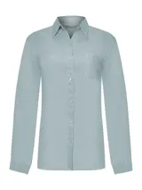 Blusa de lino orgánico color celeste de RKF, modelo Lirio, con calce regular, cuello camisero, cierre frontal con botones y un bolsillo aplicado en el pecho.