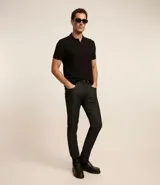 Pantalón de jean negro, modelo slim, con bolsillos laterales.