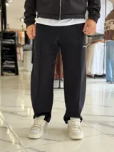 Pantalón jogging oversize de felpa, color gris, de corte recto y diseño cómodo con costuras frontales en relieve.