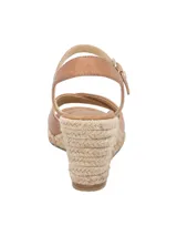 Sandalias de cuero color marrón tostado con plataforma de yute trenzado, tiras cruzadas en la parte delantera y tira ajustable al tobillo con hebilla metálica dorada.