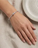 Pulsera de plata 925 compuesta por pequeñas cuentas esféricas y una cuenta central de mayor tamaño.
