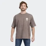 Remera de algodón con efecto lavado, color beige, de corte holgado y manga corta. Presenta un pequeño estampado de un sol con el logo de la marca en el pecho izquierdo.