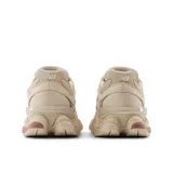 Championes New Balance modelo 9060, color beige con detalles en rosa. Capellada de malla con superposiciones de gamuza de cerdo, entresuela de doble densidad con amortiguación ABZORB y SBS, logo de TPU en la lengüeta y suela con estampado de diamantes.