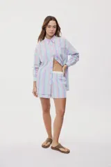 Camisa oversize de manga larga con estampado de rayas verticales en tonos rosado, celeste y verde menta. Cuenta con cuello camisero, cierre frontal con botones y un bolsillo aplicado en el pecho.