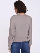 Remera color visón con escote en V cruzado y mangas largas.