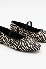 Balerinas de cuero vacuno con estampado de cebra en blanco y negro, y tira fina de cuero negro sobre el empeine.
