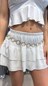 Cinturón plateado de metal con eslabones circulares.