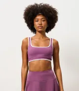 Top deportivo Get Over confeccionado en microfibra color violeta, con escote recto, copa incorporada, breteles anchos y bies contrastante en color blanco. Cuenta con banda acanalada en la base.
