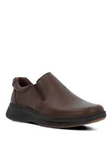 Zapatos slip on Hush Puppies modelo Hunt II, color marrón, confeccionados en cuero con elásticos laterales para un calce fácil y suela ultraliviana.