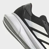 Championes de running Adidas Duramo SL 2, color negro con tres franjas laterales plateadas y entresuela blanca gruesa.