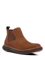 Bota tipo Chelsea de cuero color marrón, con paneles elásticos laterales y suela tecnológica Spinal Flex de EVA y goma para mayor amortiguación y soporte.