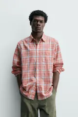 Camisa de manga larga relaxed fit a cuadros en tonos rosados, rojos y celestes. Cuenta con cuello abotonado, bolsillo de parche en el pecho y cierre frontal con botones.