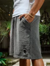 Bermuda de algodón rústico lavado color gris oscuro, con cordón ajustable en la cintura y pequeño bordado en el frente.