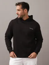 Buzo con capucha Calvin Klein de color negro, con diseño liso, mangas largas y puños y dobladillo de punto canalé. Presenta el logotipo de la marca estampado en el pecho.