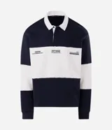 Buzo masculino confeccionado en algodón con felpa y diseño de bloques rayados en color azul marino y blanco. Presenta cuello polo, cierre frontal parcial con botones, manga larga y estampa frontal con íconos y texto.