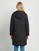Campera reversible de corte largo con diseño capitoneado. Un lado presenta un tono verde oliva y el otro un tono negro, ambos con cierre frontal mediante botones a presión y bolsillos laterales.