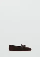 Mocasines de gamuza color marrón oscuro, con detalle de lazo en el empeine y suela plana.