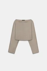 Top crop color beige, de cuello barco y manga larga, con bajo redondeado.