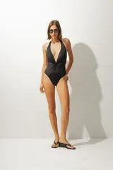 Traje de baño entero rojo con escote halter y nudo en el centro.