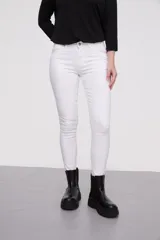 Pantalon jean de corte skinny y calce medio, color blanco, con bolsillos laterales y traseros.
