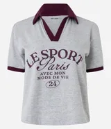 Remera gris de algodón con cuello polo y mangas cortas con ribete bordó. Estampa frontal con texto "Le Sport Paris".
