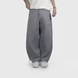 Pantalón jean de corte ultra baggy, color gris, con diseño holgado y tiro medio.