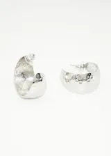 Aros plateados tipo argolla con textura irregular.