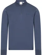 Chomba azul de manga larga con cuello polo y cierre de cremallera parcial. Tiene un pequeño logo de la marca en el pecho. Confeccionada en algodón orgánico.