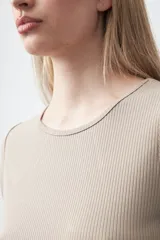 Remera de manga corta confeccionada en tejido acanalado, con cuello redondo y ajuste al cuerpo.