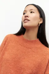 Polera de punto color verde agua, con cuello alto y mangas largas.