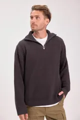 Sweater verde oscuro de punto con cuello alto y cierre de cremallera parcial. Tejido de canalé vertical.