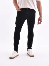 Jean skinny negro de tiro medio, corte ajustado y largo al tobillo.