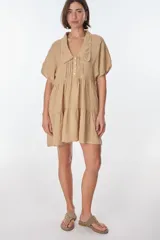 Vestido corto azul de lino italiano con cuello Peter Pan con detalle de encaje, escote en V con botones frontales y corte imperio con volados en la falda. Mangas cortas tipo mariposa.