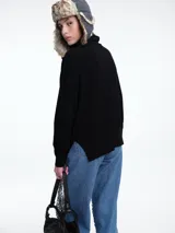 Sweater de cuello polera con hombros caídos y diseño de calce holgado. Presenta terminaciones acanaladas en puños y ruedo, confeccionado en tejido de punto suave.