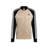 Campera deportiva Adidas Originals SST de corte ajustado, con diseño combinado en color tostado en el cuerpo y negro en las mangas. Cuenta con escote bomber, cierre frontal completo y las clásicas tres tiras blancas a lo largo de las mangas. Incluye el logo del trifolio bordado en el pecho.