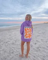 Canguro oversize color lila con capucha, bolsillo frontal tipo canguro y gran estampado trasero con diseño floral y la frase "USE YOUR ENERGY".