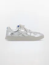 Zapatillas deportivas plateadas con detalles en blanco y azul.