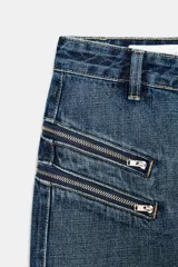 Falda de denim azul con tiro medio, cierre frontal completo con cremallera y detalles de bolsillos falsos con cremalleras en la parte delantera.